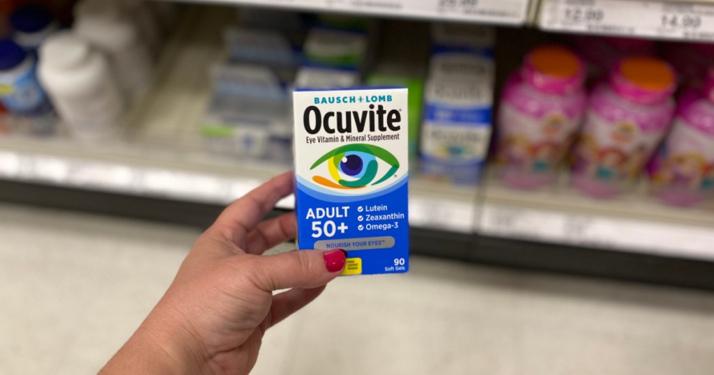 hand holding ocuvite vitamins with blurred background
