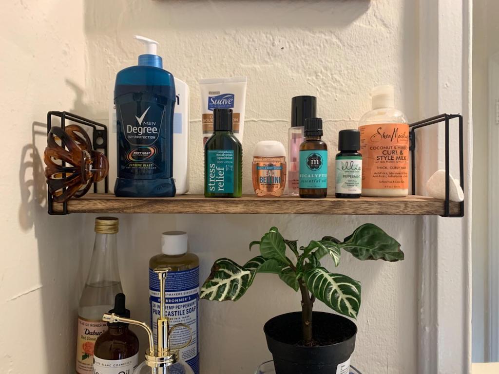 floating shelves in bathroom with personal care products 