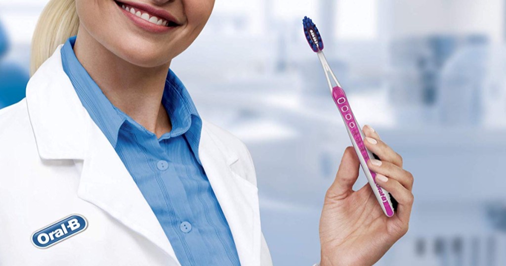 woman wearing oral-b lab coat holding onto pink toothbrush