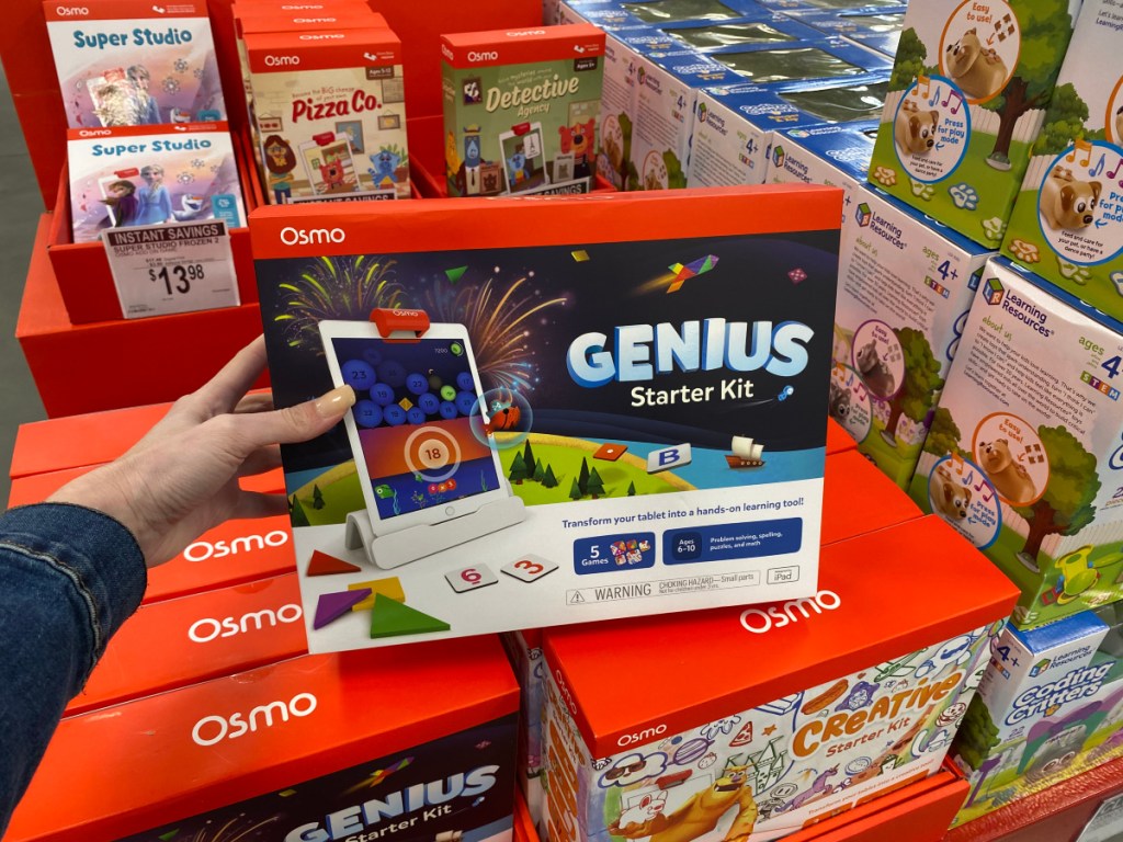 hand holding an Osmo genius Starter Kit in store against a display