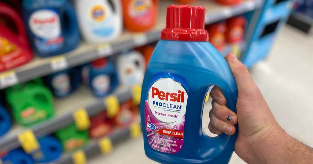 hand holding a bottle of Persil laundry detergent