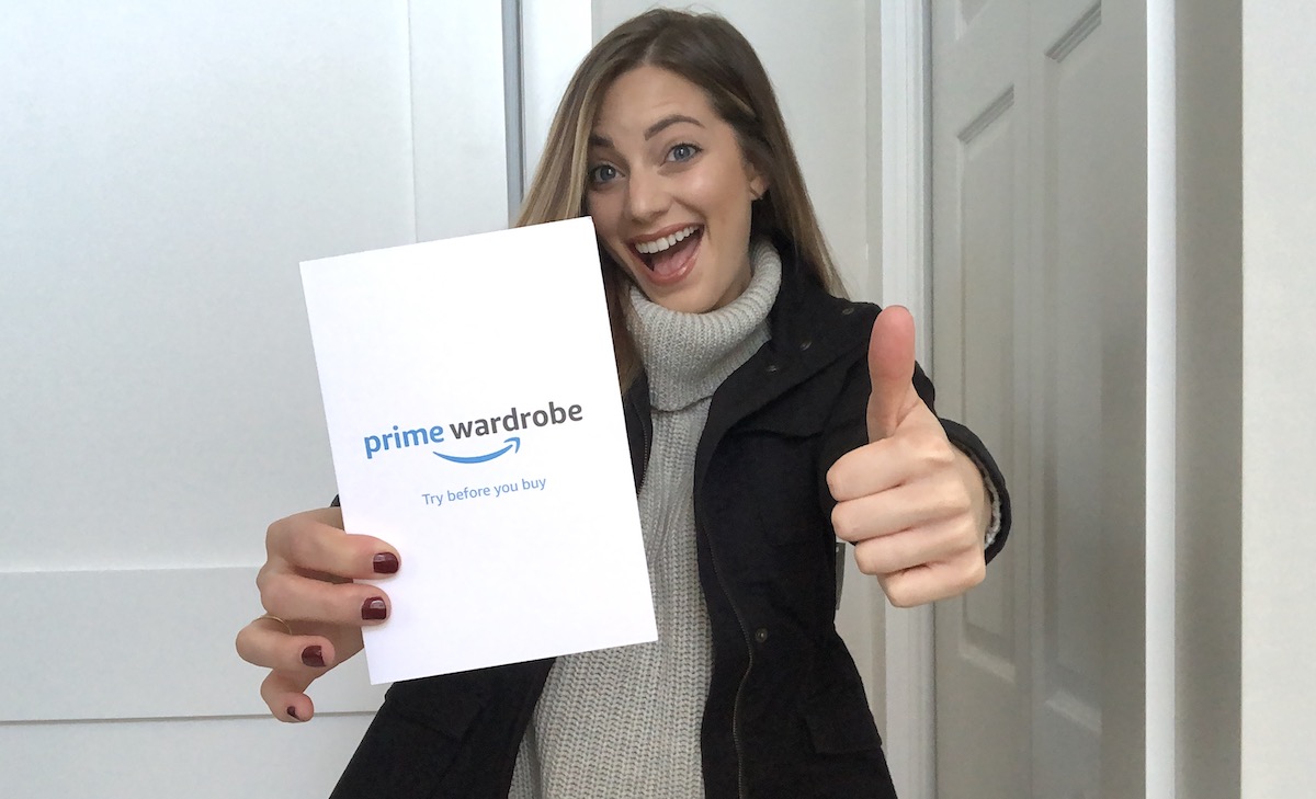 woman holding prime wardrobe card smiling with thumbs up