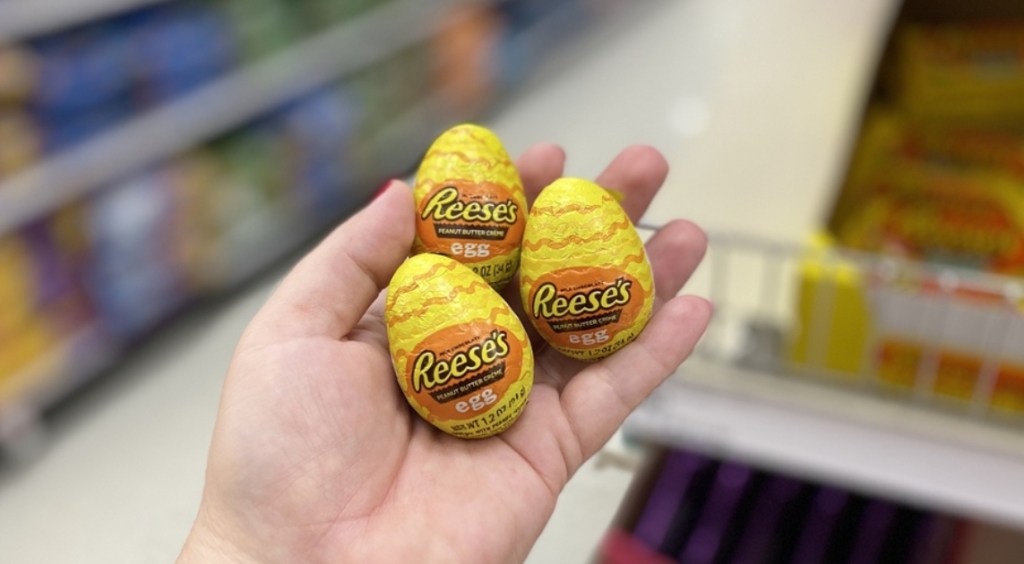 hand holding 3 Reese's Creme Eggs at Target