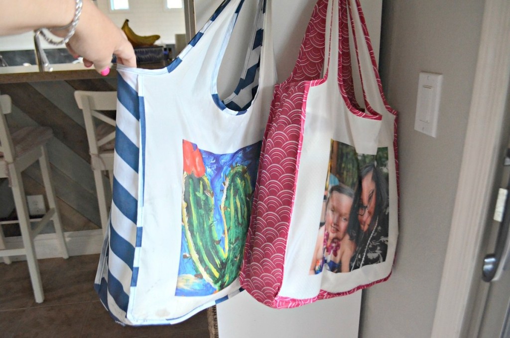 hand holding reusable bag with cactus and family photo on it