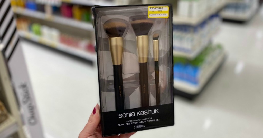 hand holding clearance makeup brushes in a store