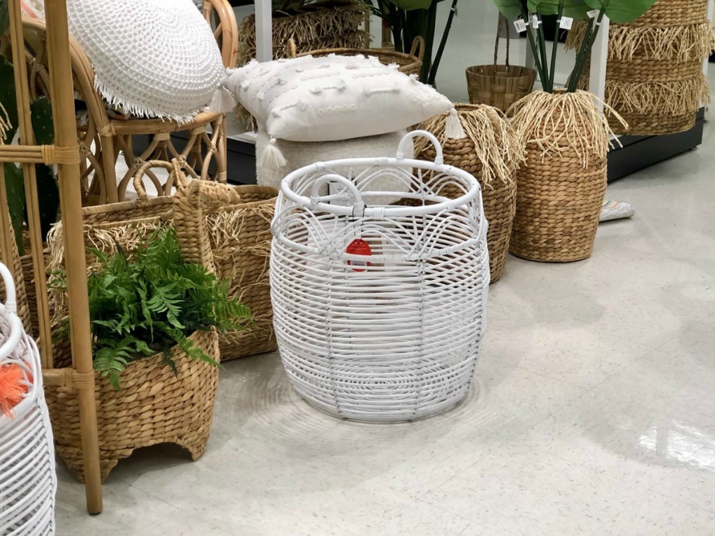 baskets stacked up and arranged in store wiht decorative pillows