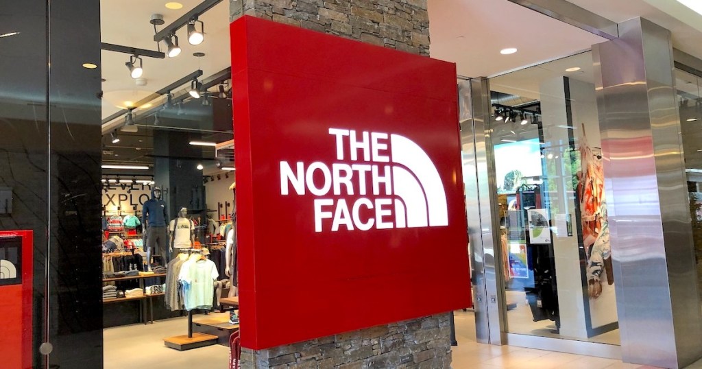 red the north face sign in front of store 
