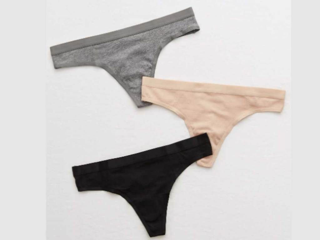 stock image of three pairs of american eagle aerie cotton thongs in gray, black and beige