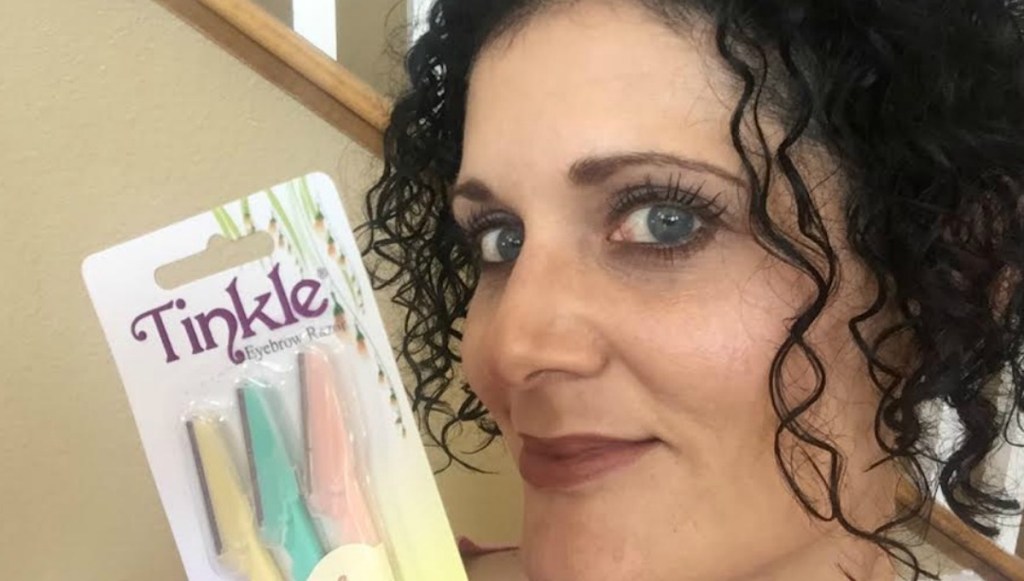 woman holding a package of tinkle razors 