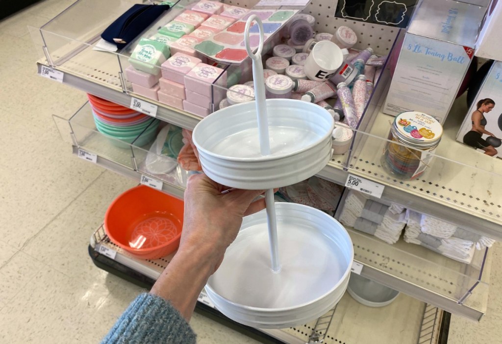 hand holding white two tiered metal serving tray in Target store