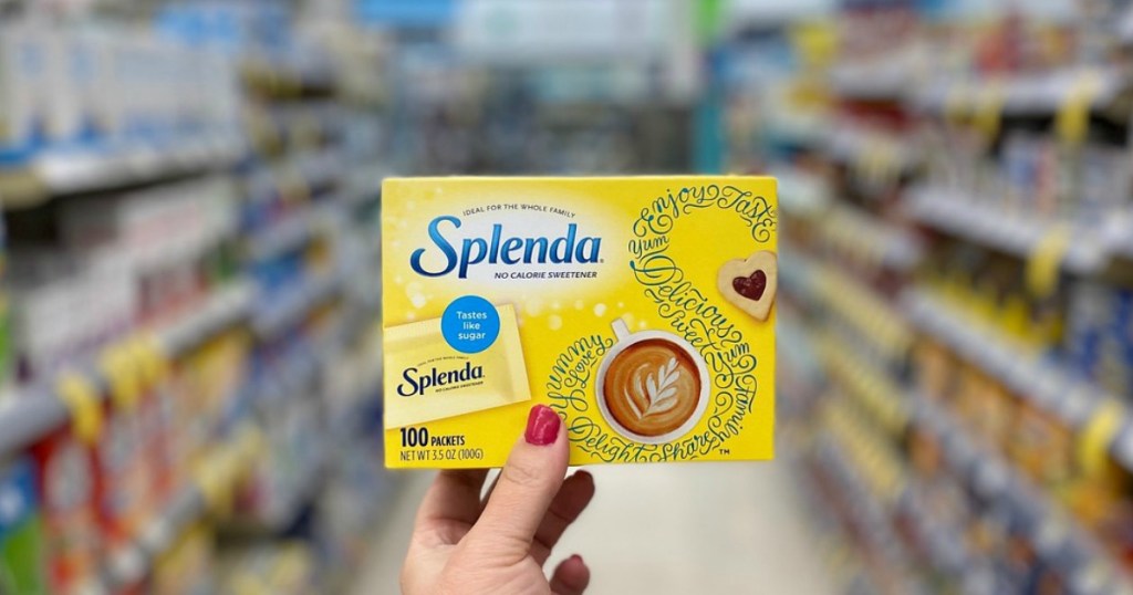 hand holding artificial sweetener in a store