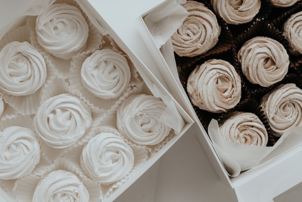 white and brown wedding cupcakes in boxes