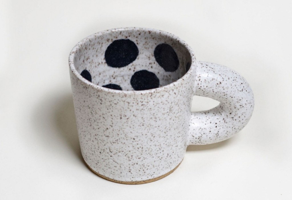 cream speckled coffee mug with black dots inside