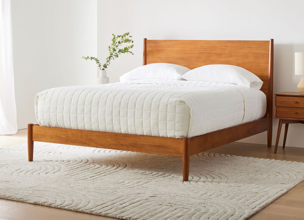 wood mid century bedframe from west elm in staged room