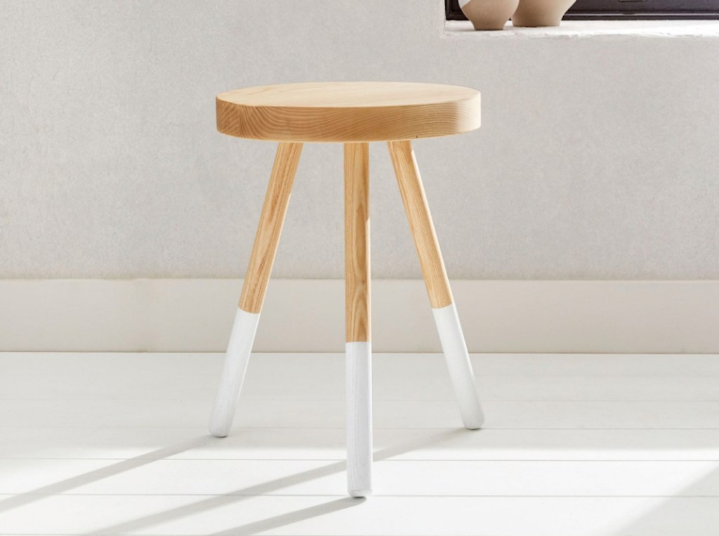 wood white dipped stool on floor