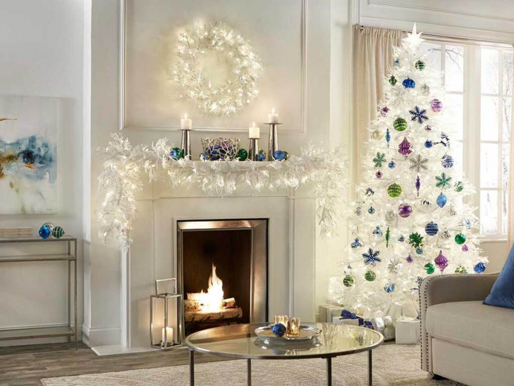 Home Accents Holiday 30 in. Pre-Lit LED Winter Crest White Flocked Artificial Christmas Wreath in a living room above a fireplace