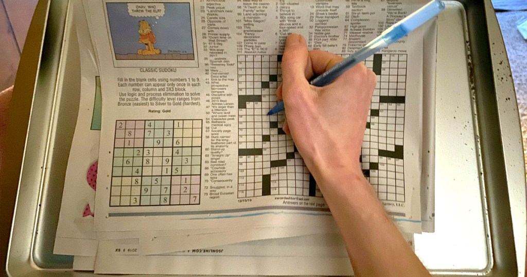 woman doing crossword puzzle