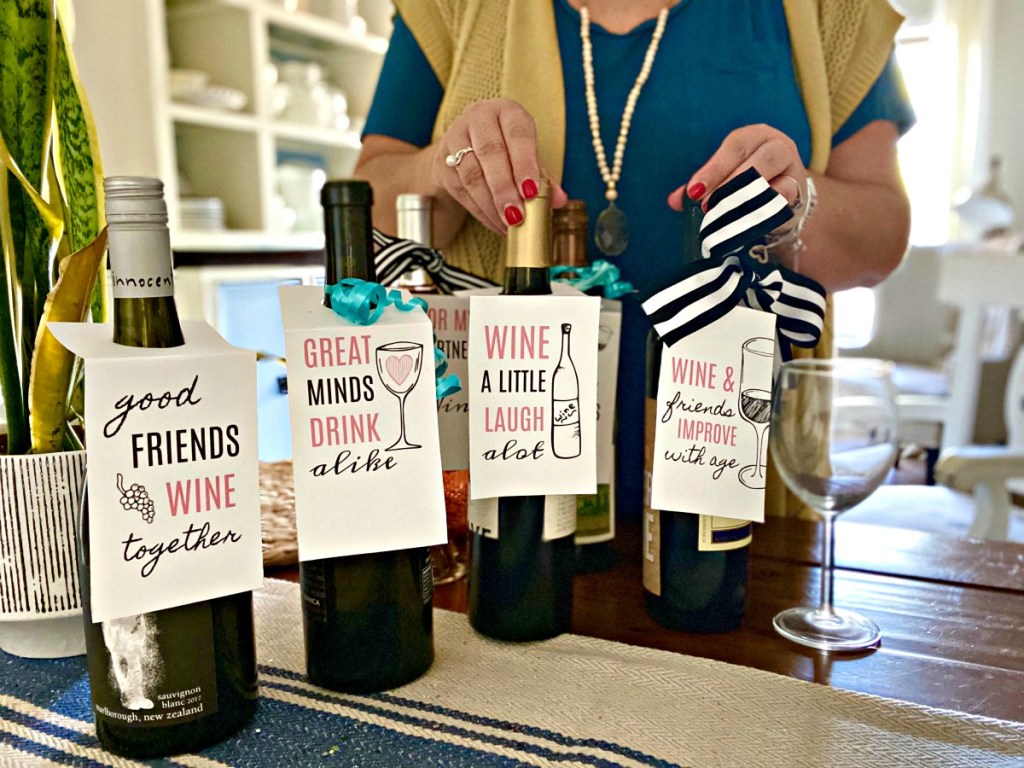 woman holding wine with gift tags