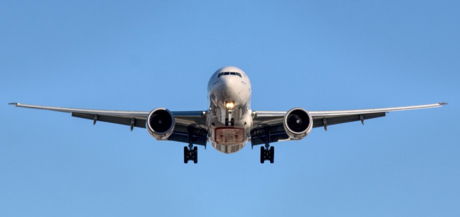 airplane flying in a blue sky