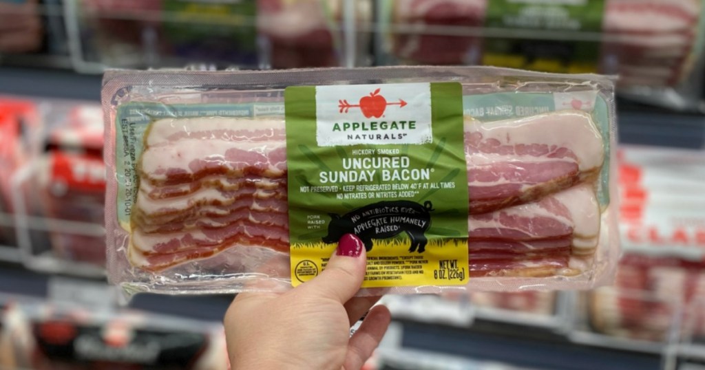 Woman's Hand holding up Applegate Bacon
