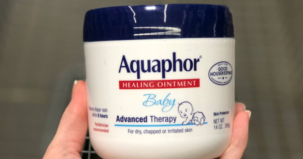 hand holding an Aquaphor Baby Healing Ointment Jar