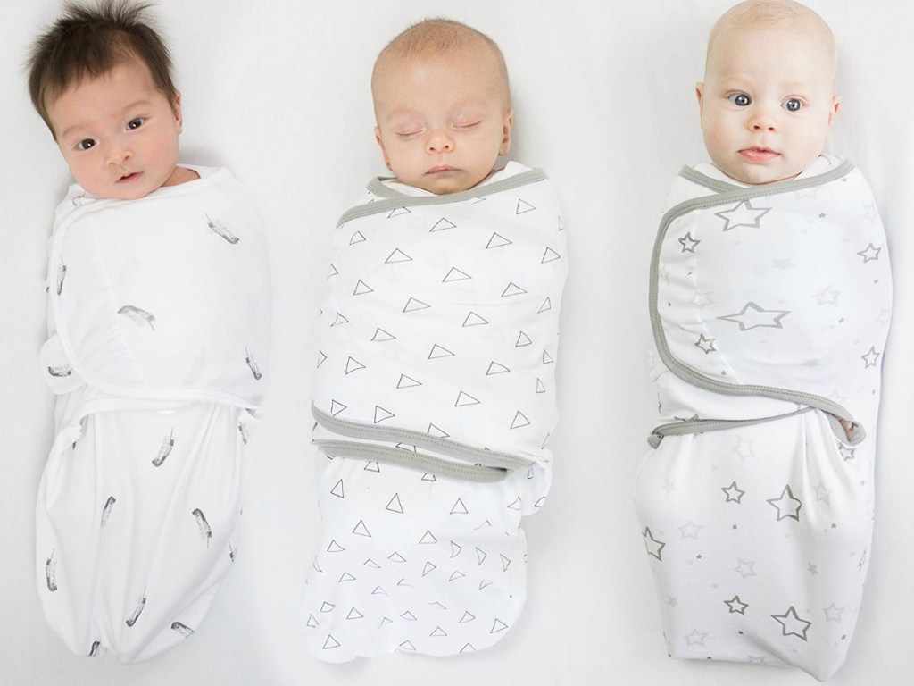 Three different babies wearing swaddle blankets in different prints