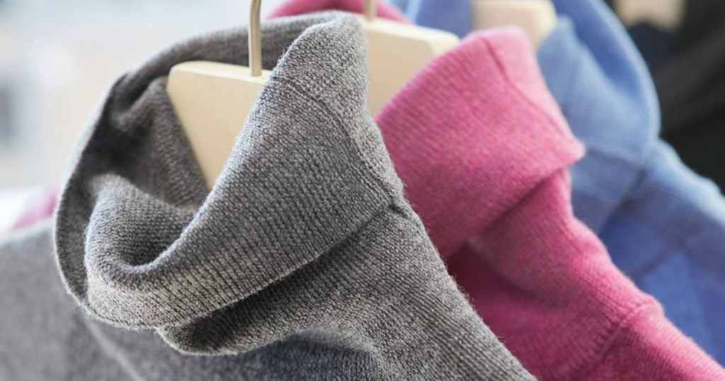Women's turtleneck sweaters on hangers in three colors