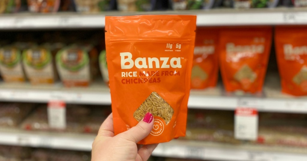 Woman's hand holding up a bag of Banza Rice