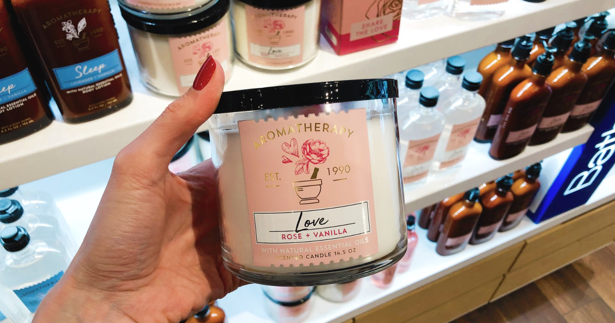 woman hand holding Bath &amp; Body Works Aromatherapy Love Candle in store
