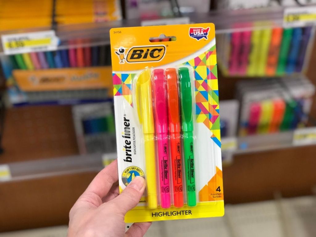 human hand holding package of slim highlighters