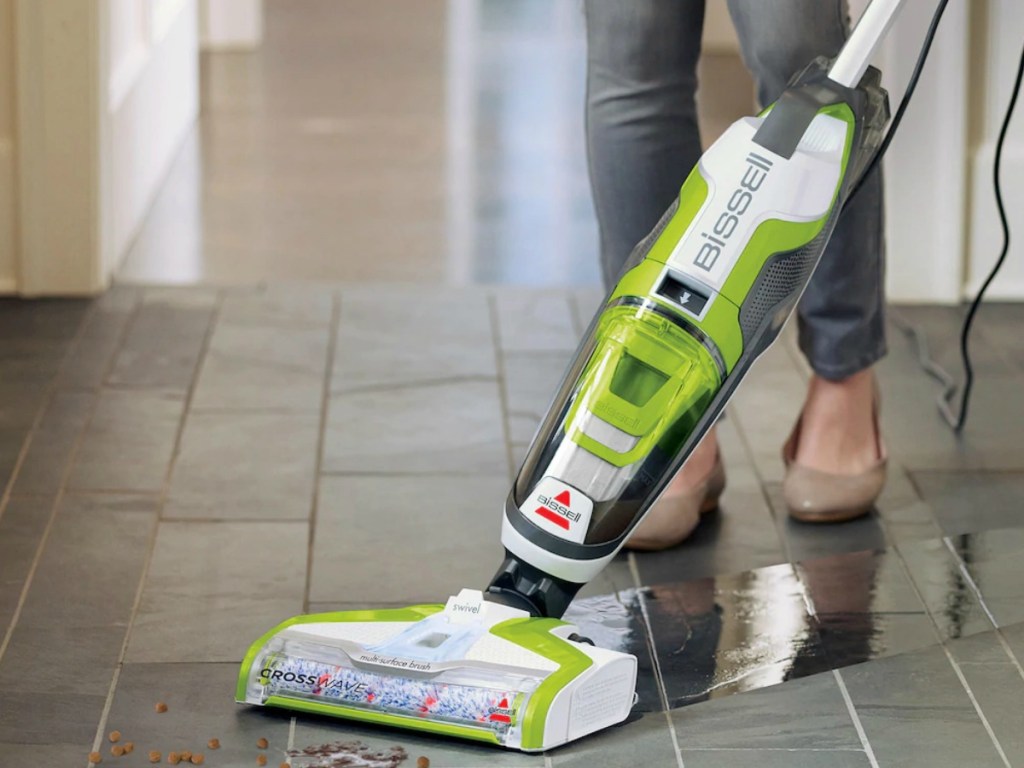 All-in-one style floor cleaning vacuum in green and black on a hardwood surface
