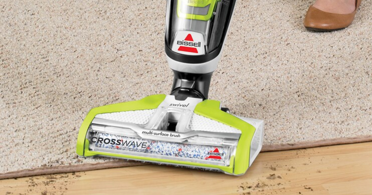 bissell crosswave Vacuum cleaning up dirt from a rug and hardwood floor