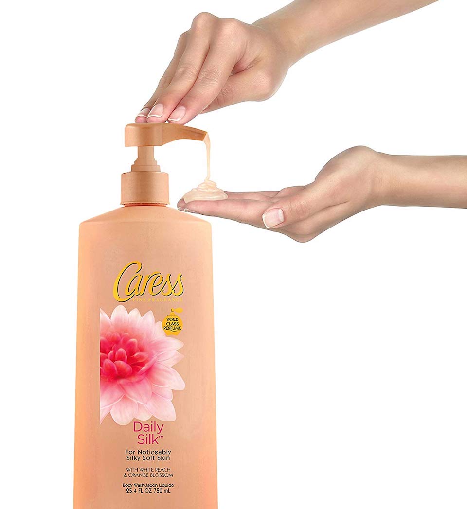 person pushing on a body wash bottle