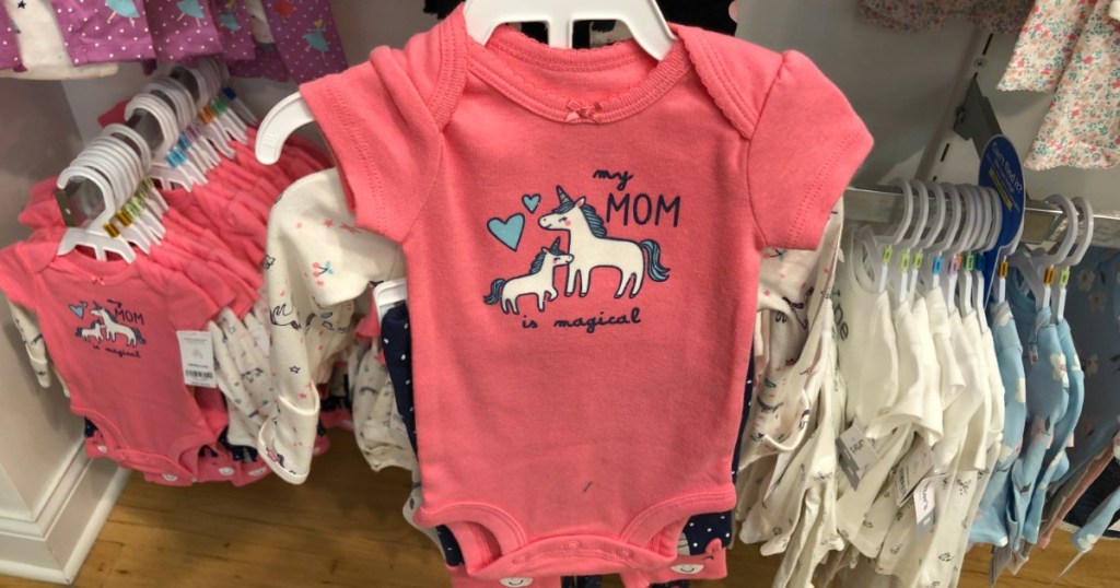 Carter's bodysuit with a unicorn on it on a hanger