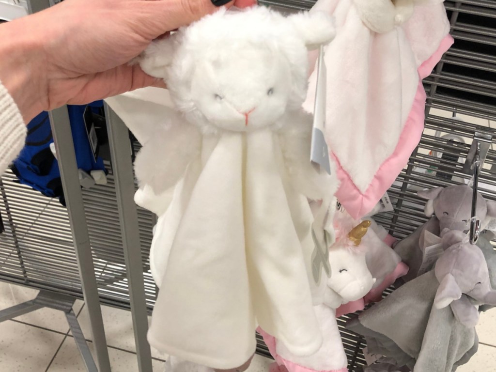Woman's Hand holding Carter's Lamb security blanket at kohl's