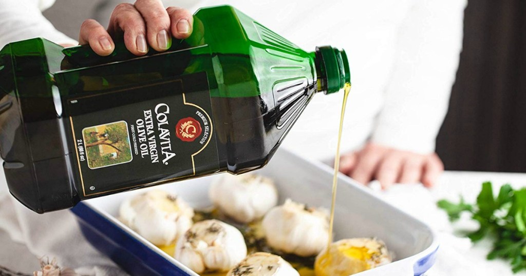 man pouring Colavita extra virgin olive oil over a pan of garlic