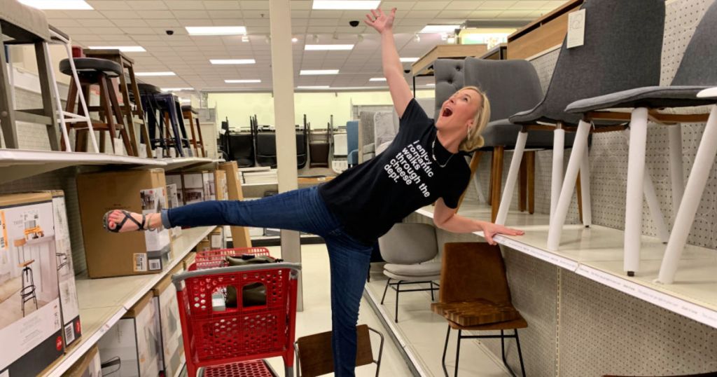 woman standing on brown chair in isle at target