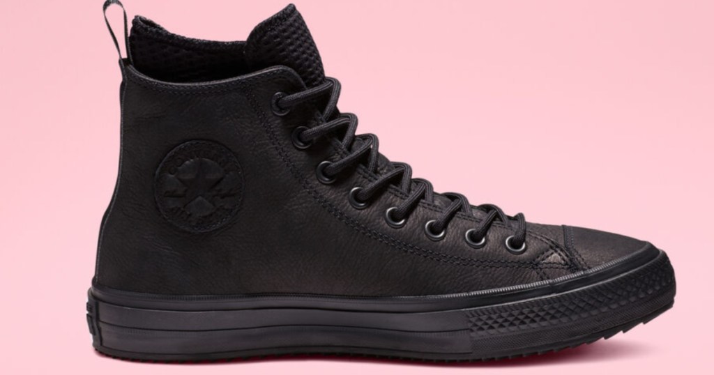 black pair of converse Chuck Taylor All Star Waterproof Leather High Top with pink background