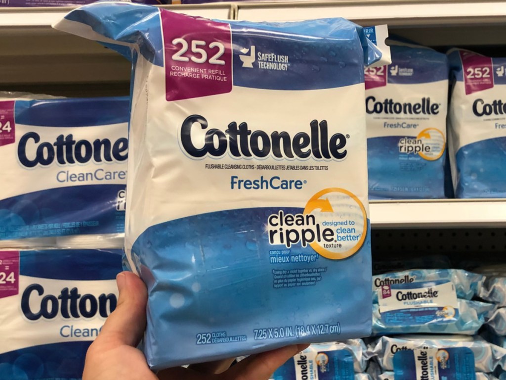 Man holding flushable wipes in store asile