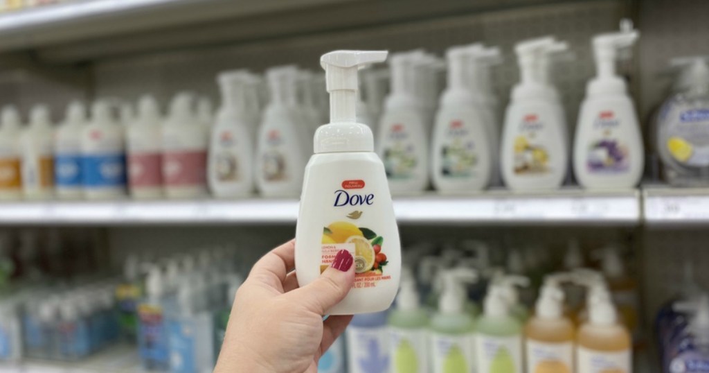 hand holding a bottle of Dove hand wash