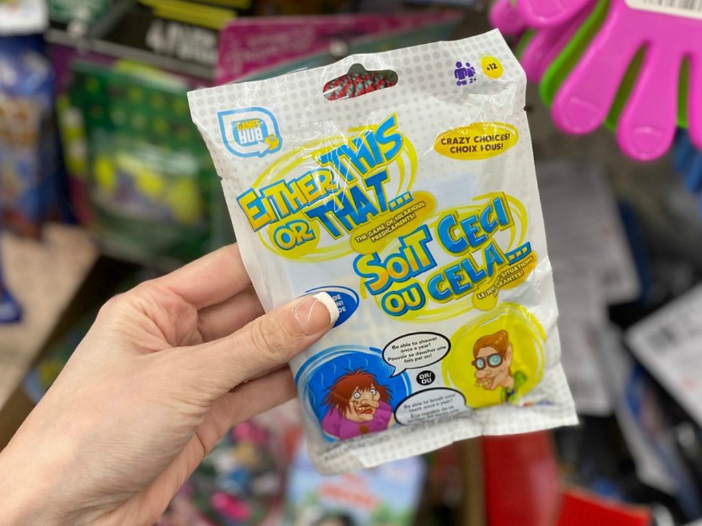 hand holding bag containing mini game in store