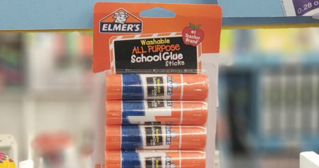Large package of school glue sticks in store near school supplies display