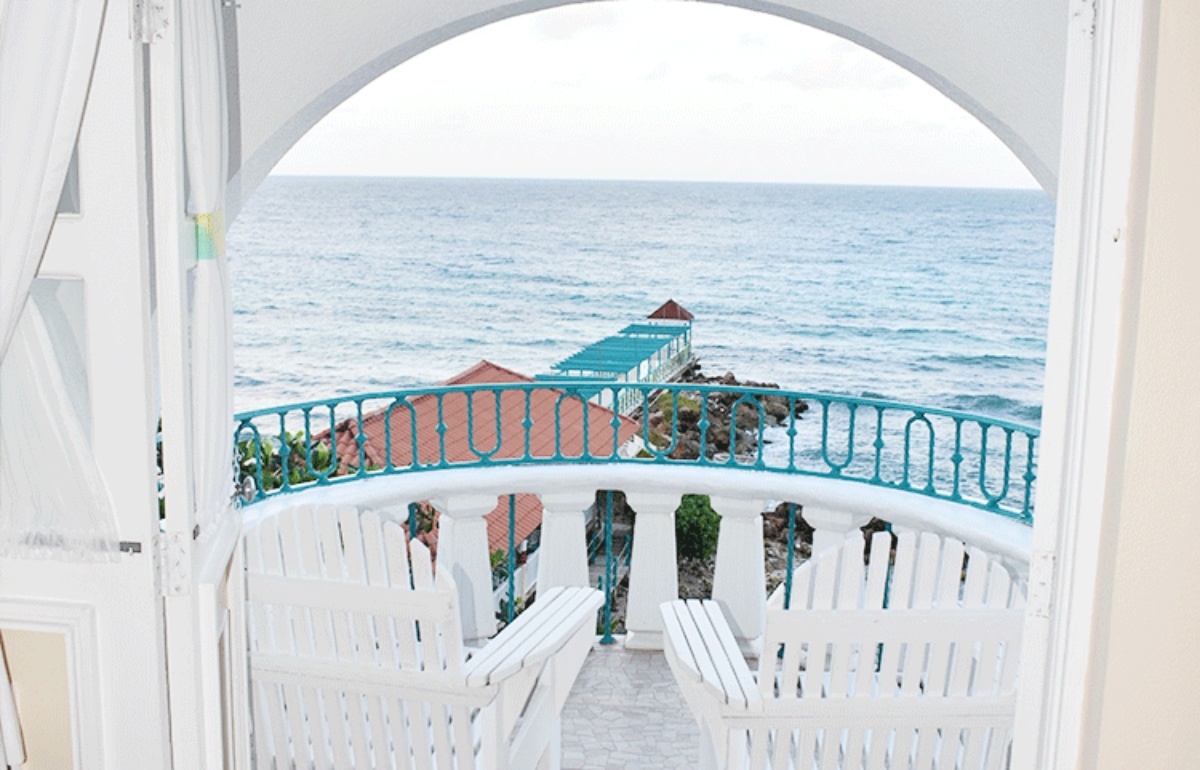 room with balcony and ocean view