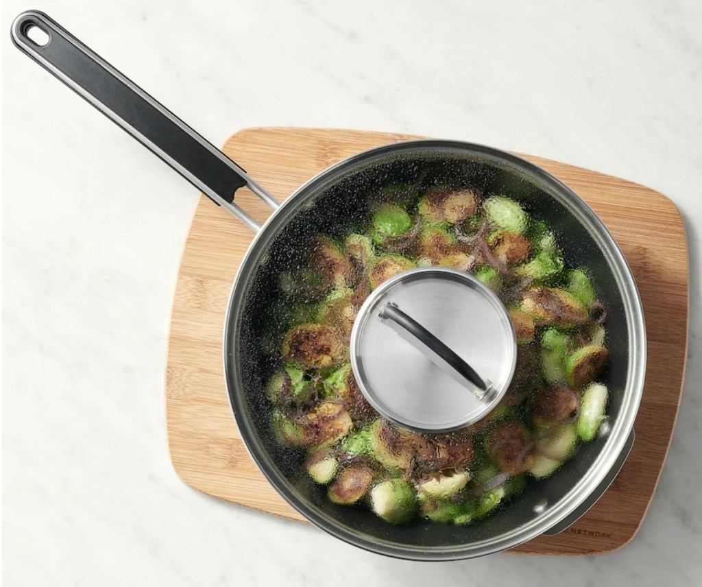 nonstick saute-style pan with meal inside and glass lid on top