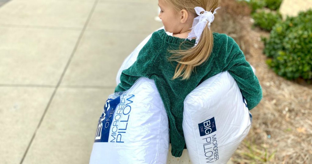 Girl holding The Big One pillows