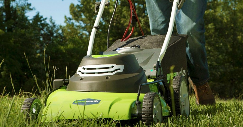 Large green lawnmower mowing the grass