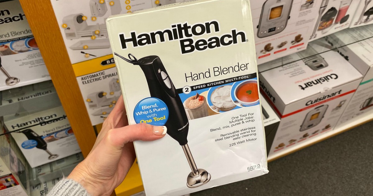 Woman holding a box of a hand blender in-store