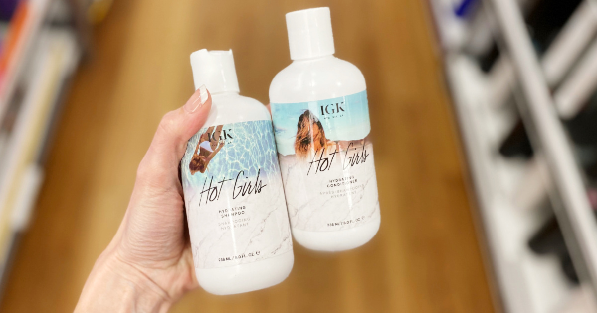 woman holding two IGK Hot Girls Shampoo and Conditioner Smaller Bottles