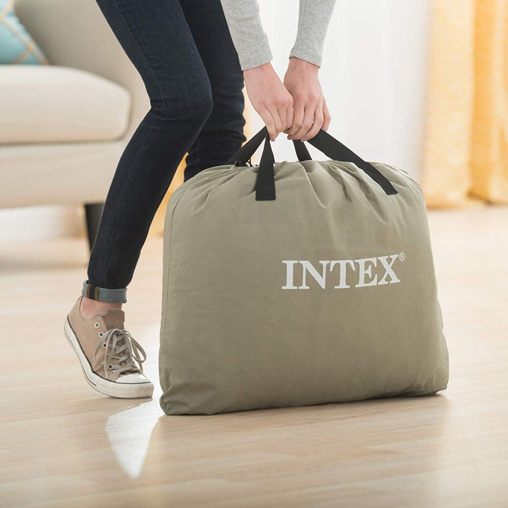 Woman lifting Intex air mattress stored in duffel bag
