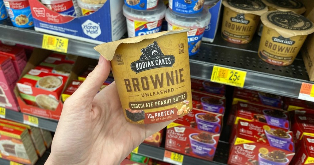 woman holding a cup of Kodiak Cakes Brownie Unleashed mix